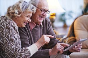 happy-seniors-networking-together-at-home