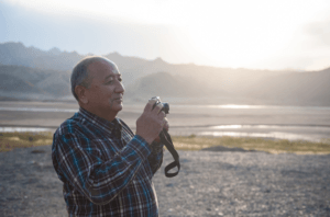 Hispanic man with camera